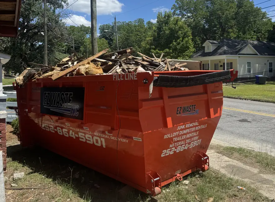 Roll-off dumpster loaded with construction debris