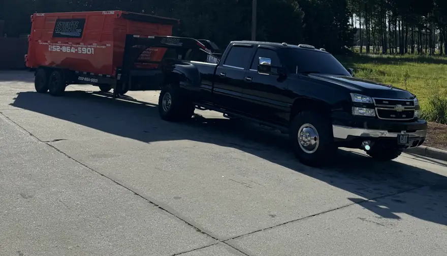 EZ Waste truck and dumpster trailer parked and ready