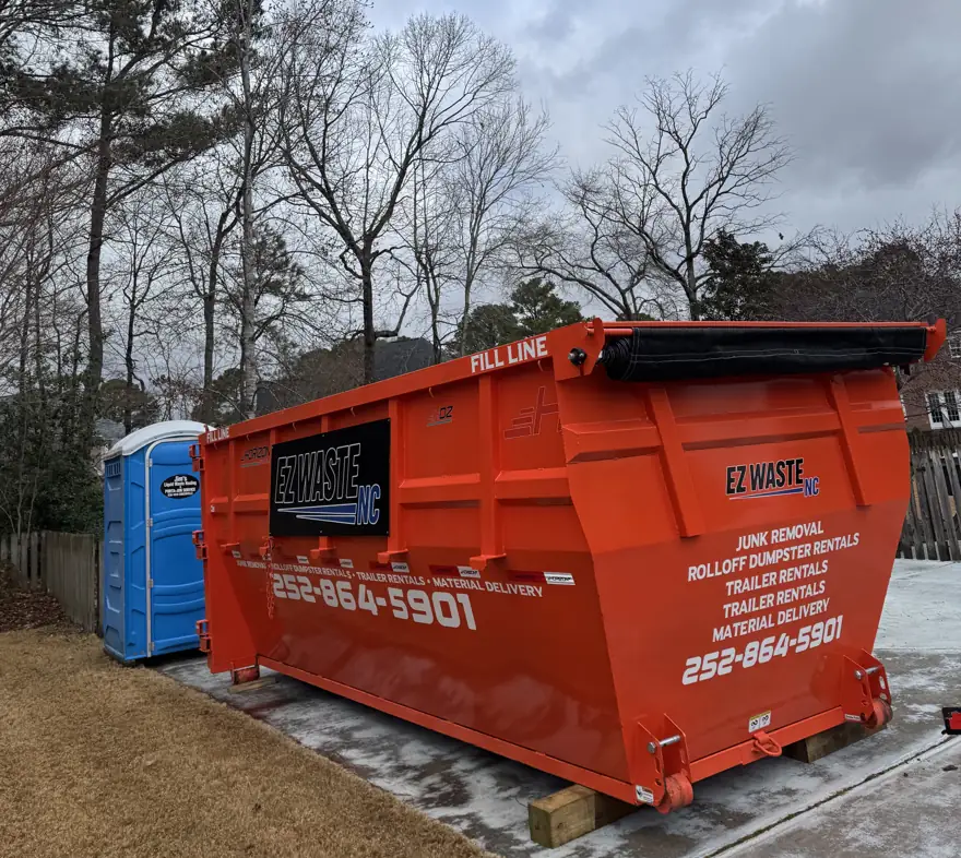 EZ Waste roll-off dumpster placed beside a house